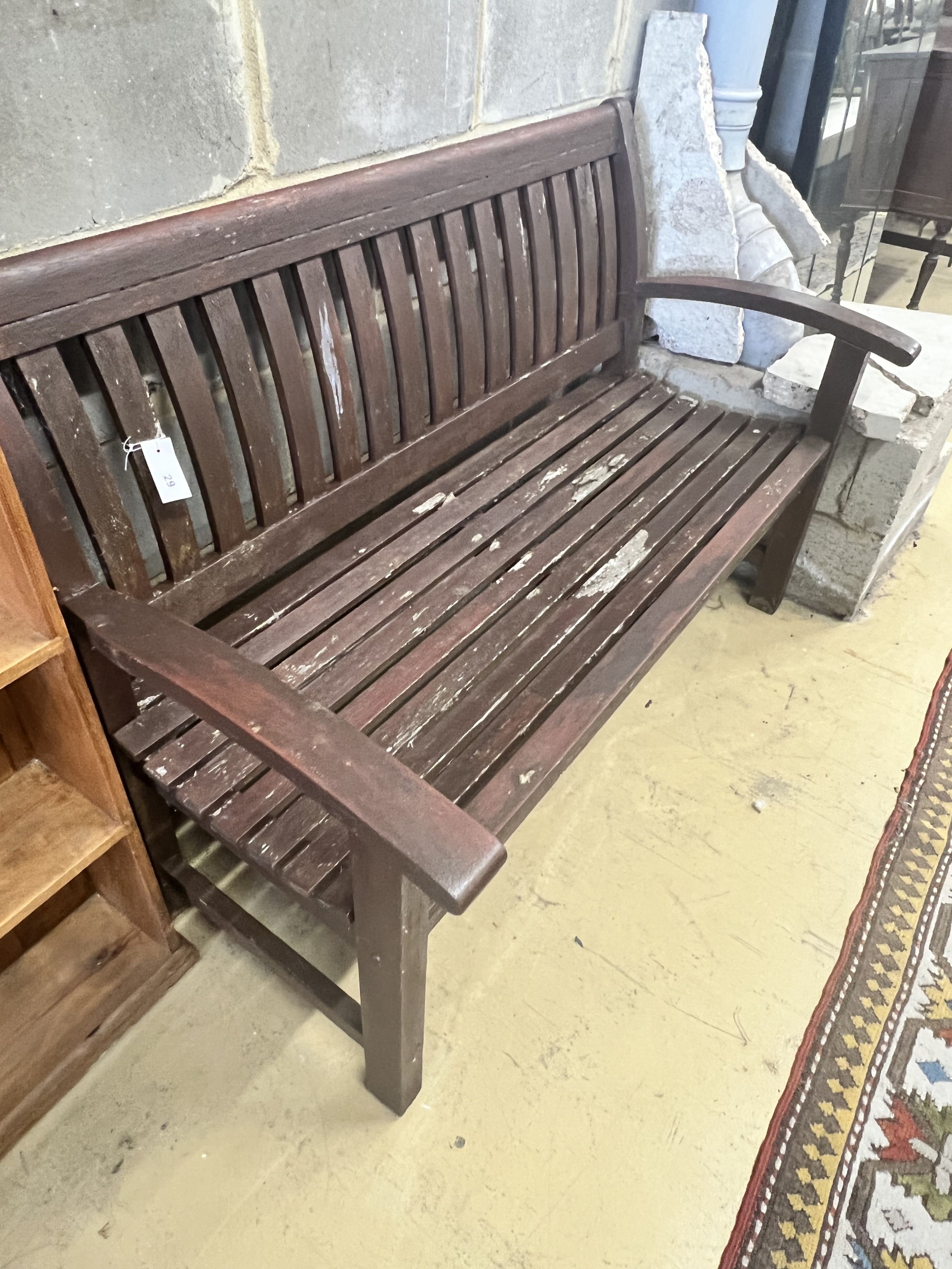 A stained teak slatted garden bench, 138 x 58cm height 92cm